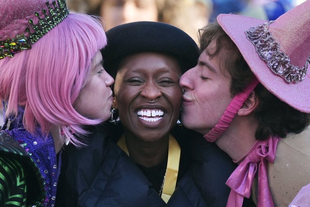 Harvard University's Hasty Pudding Theatricals Woman of the Year Cynthia Erivo smiles while kissed by two character actors during a parade in her honor, Wednesday, Feb. 5, 2025, in Cambridge, Mass. (AP Photo/Charles Krupa)