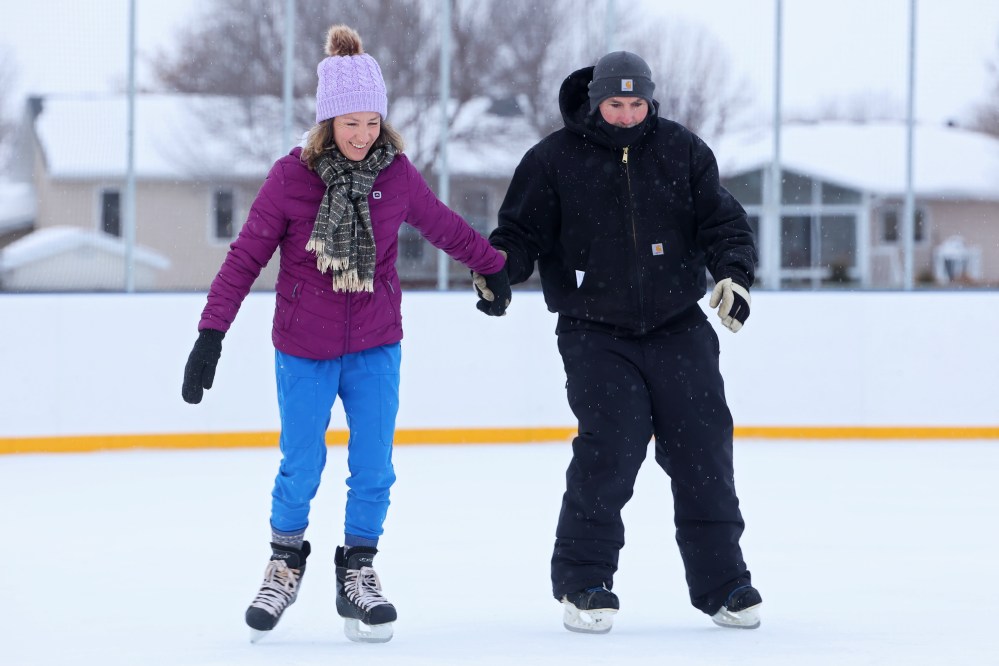 Chiara and Derek Gross skate together during the grand opening
of the new North Hill Outdoor Rink
at the Sportsplex track infield on
Friday afternoon.