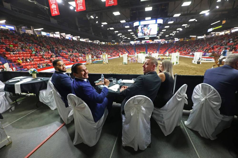 Manitoba Premier Wab Kinew (centre left) is joined by his assistant Seeon Smith (at left), Provincial Exhibition of Manitoba president Clint Swain and wife Jenna Swain during an evening show at the Royal Manitoba Winter Fair in March.