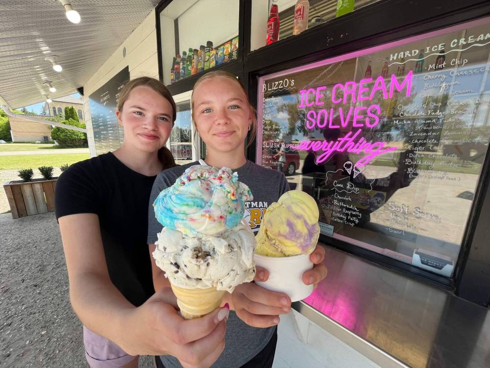 Chloe Williment (left), from Oak Lake, holds a double cone with scoops of chocolate chip cookie dough and birthday party ice cream, while her friend Molly Struder from Virden chose a cup of lavender lemonade on a bright and sunny July afternoon at Joe Dandy’s Drive-In at Oak Lake.