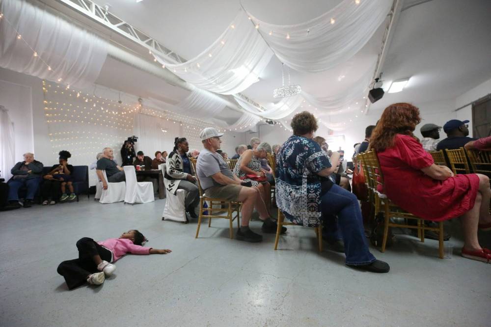 A bored child entertains herself on the floor during a public town hall meeting with Brandon Mayor Jeff Fawcett and Brandon East MLA Glen Simard at The Backyard on Aberdeen in September.