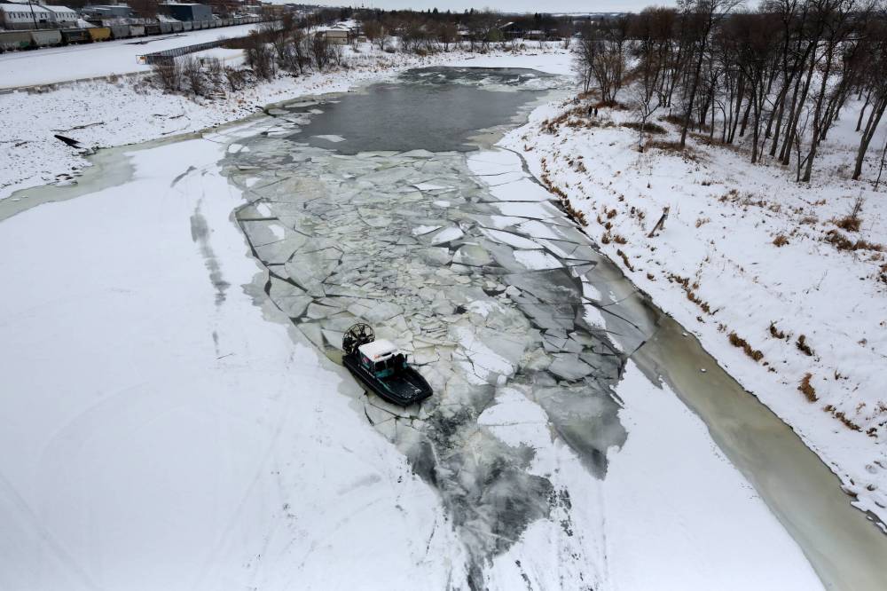 Operating a Severboat 650 airboat, members of the Hutterian Emergency Aquatic Response Team search for signs of Jeffrey Floresco along the Assiniboine River in Brandon in early December. The vehicle, seen here just west of the First Street bridge, was making several passes along the river near the Canadian Pacific-Kansas City Railway line that parallels Pacific Avenue. Floresco was last seen on Nov. 21 at about 6 a.m. in the 400 block of Rosser Avenue.