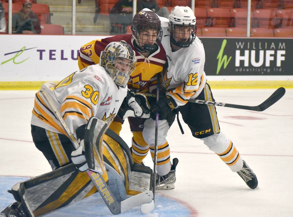 Malcolm MacDonald of the Sydney Mitsubishi Rush battles with Nolan Saunderson of the Brandon Wheat Kings to the side of goaltender Matt Michta during Telus Cup national U18 hockey action at the Membertou Sport and Wellness Centre. Brandon won the game 7-4. (Jeremy Fraser/Cape Breton Post)