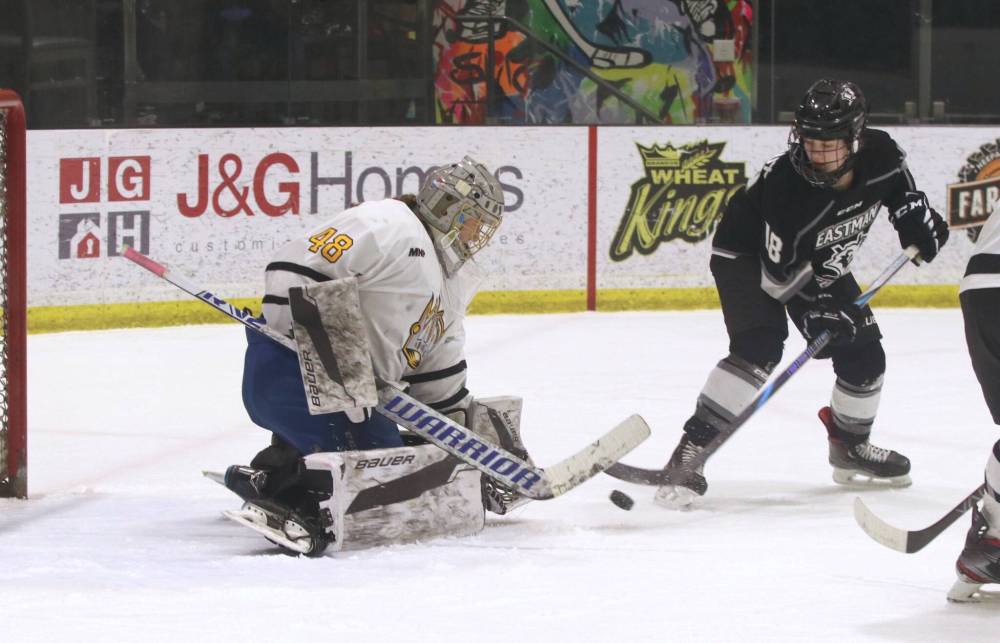 Brandon Wheat Kings goalie Danica Averill (48) makes one of her 15 saves in the first period as Eastman Selects forward Delainey Rigaux (18) hunts for the puck during Manitoba Female Hockey League U18 AAA at J&G Homes Arena on Sunday afternoon. (Perry Bergson/The Brandon Sun)
