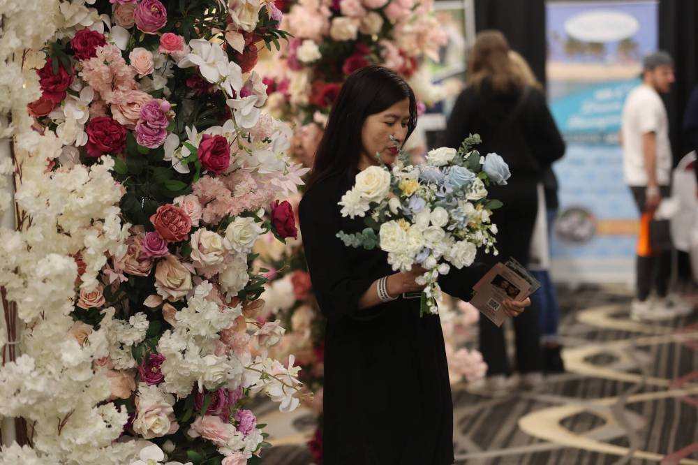 Sheryl Stodomingo of Weddings by Abby checks out a Westman Wedding Expo schedule while she waits for customers last year. This year’s Westman Wedding Expo takes place in the Keystone Centre’s UCT Pavilion on Jan. 26.