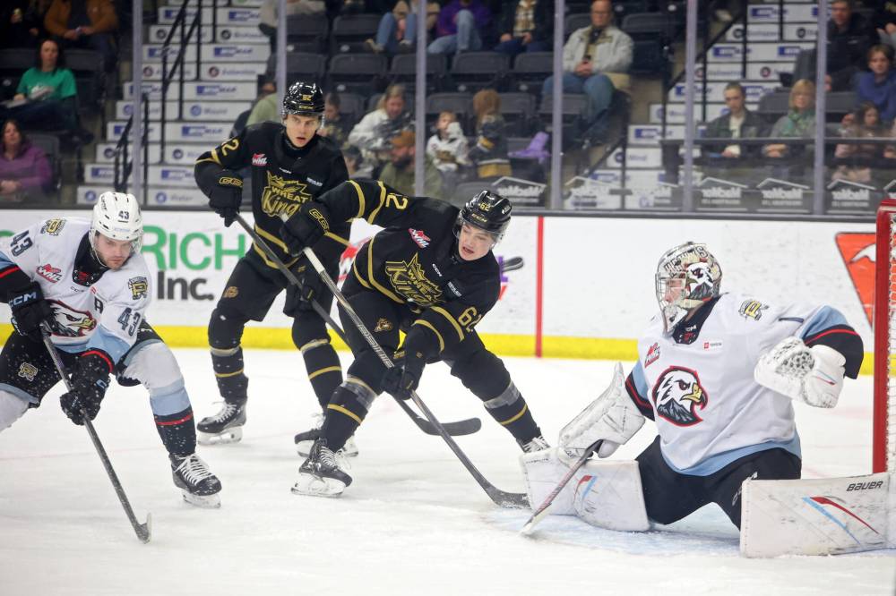 Dominik Petr and Nicholas Johnson look for the puck in front of goalie Stebetak. (Tim Smith/The Brandon Sun)