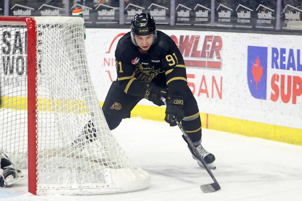 Nolan Flamand wraps the puck around the net behind goalie Ondrej Stebetak Friday evening. (Tim Smith/The Brandon Sun)