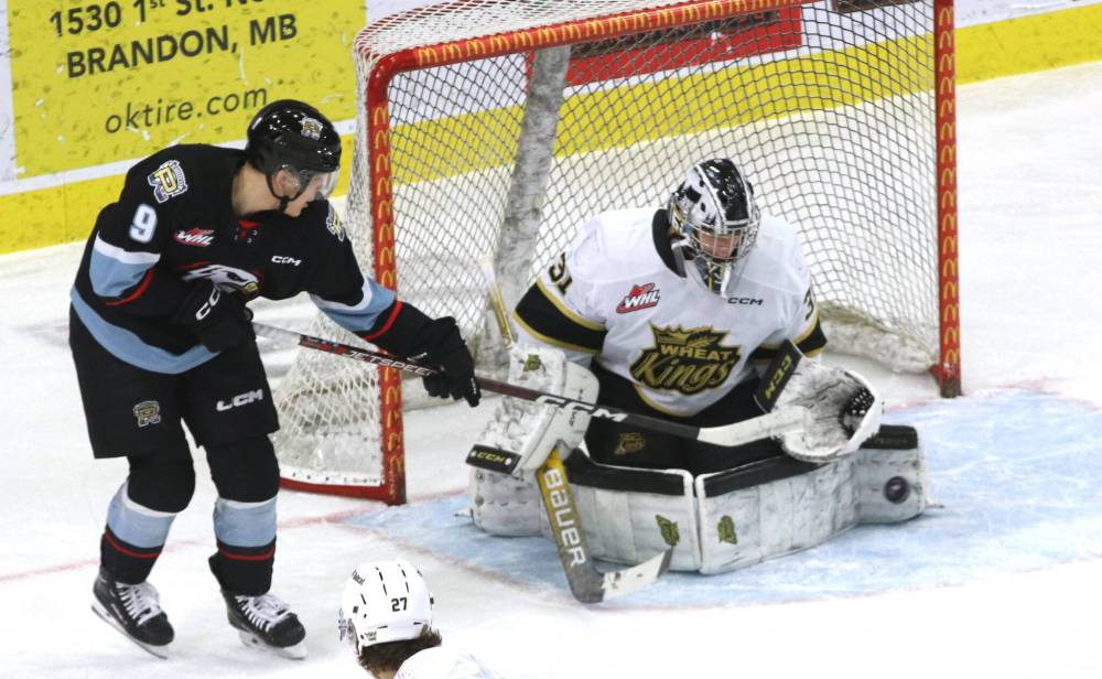 Brandon Wheat Kings goalie Carson Bjarnason makes a pad save as Portland Winterhawks forward Aidan Litke reaches for the puck during a 2023 Western Hockey League game at Westoba Place. The Winterhawks return to Brandon to play the Wheat Kings on Friday evening.
