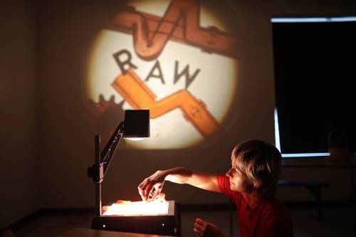 Leanne Zacharias with the quartet DUODUO adjusts objects being projected onto a wall during setup at the Art Gallery of Southwestern Manitoba on Friday, ahead of the 2025 Wheat City Nuit Blanche, which runs tonight from 5 p.m. to 10 p.m. DUODUO will be performing Aurora Scores at 6 p.m. and 9:30 p.m. in the AGSM painting studio. The quartet will create music that interacts with a video of northern lights projected during the performance. (Tim Smith/The Brandon Sun)