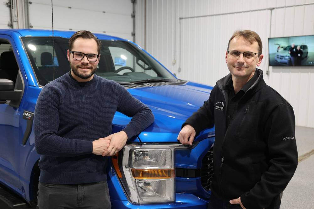 Sisson Auto owners Jaydan Sisson (left) and his father Jason pose for a picture at the building and car wash they acquired Friday evening. (Abiola Odutola/The Brandon Sun)