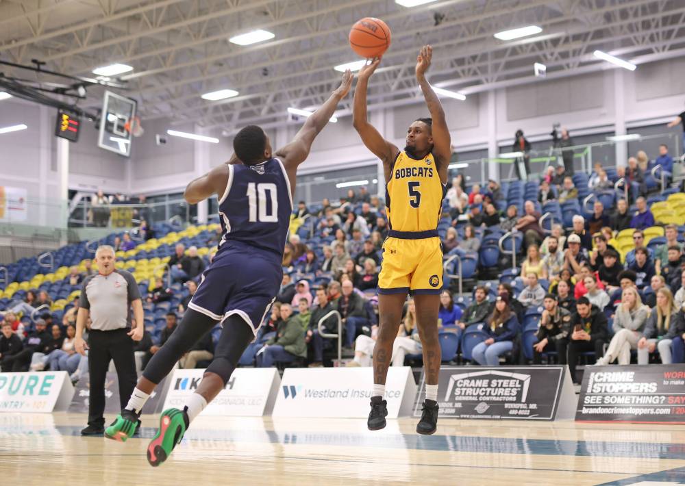 Dewayne Thompson shoots as Ijah Nelson tries to block on Friday at the BU Healthy Living Centre. (Tim Smith/The Brandon Sun)
