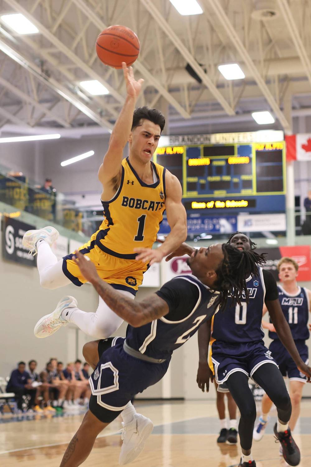 Travis Hamberger collides with Keivonte Watts of the MRU Cougars while going up for a layup during Friday night’s game at the BU Healthy Living Centre. (Tim Smith/The Brandon Sun)