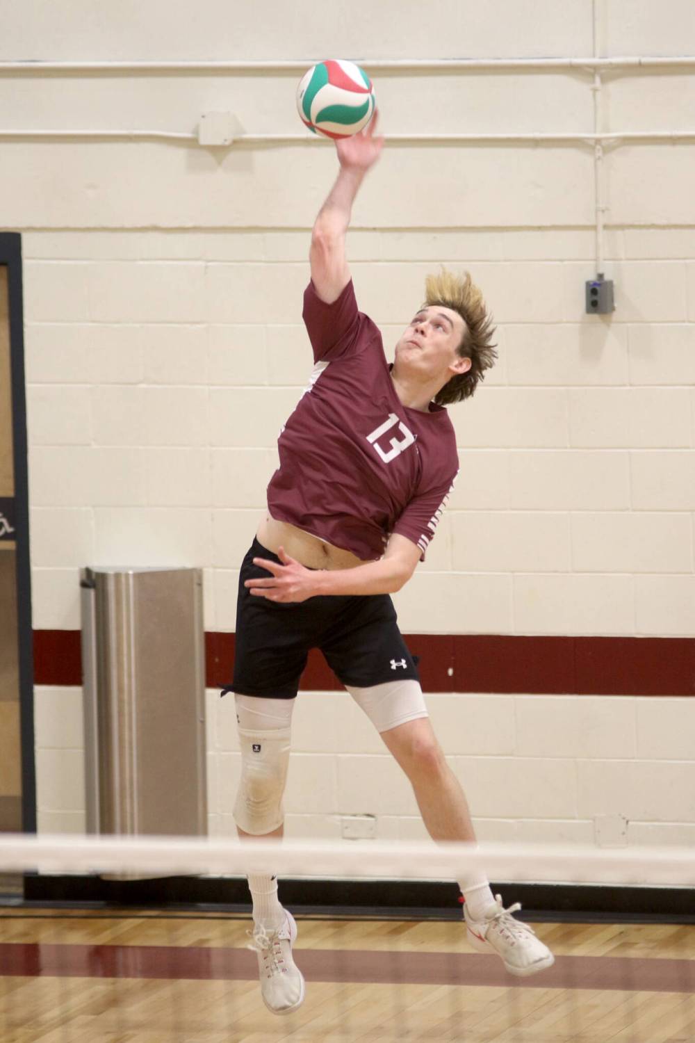 Carter Lehmann serves for the Assiniboine Cougars men's volleyball team against the CMU Blazers on Saturday afternoon. (Thomas Friesen/The Brandon Sun)