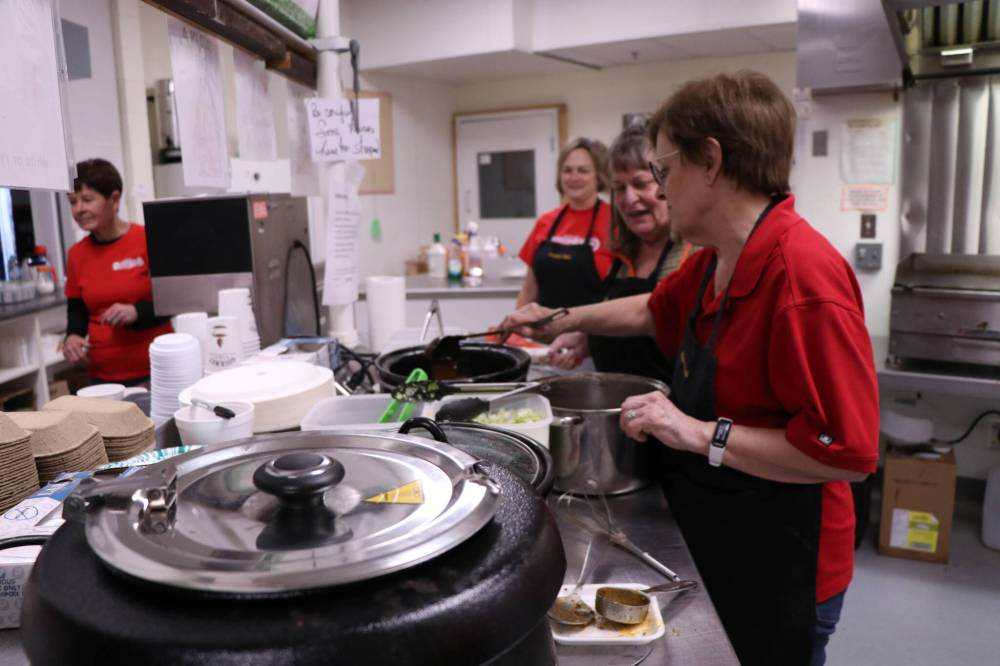 Volunteers work feverishly in the Pilot Mound Millenium Recreation Complex canteen, serving up refreshments with the hospitality and warm community spirit the town is known for. (Matt Packwood/The Brandon Sun)