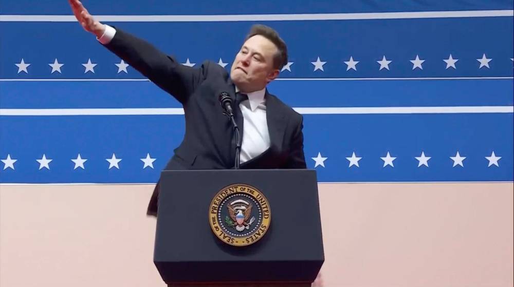Elon Musk gestures while speaking at an indoor presidential inauguration parade event in Washington on Monday. (The Associated Press)
