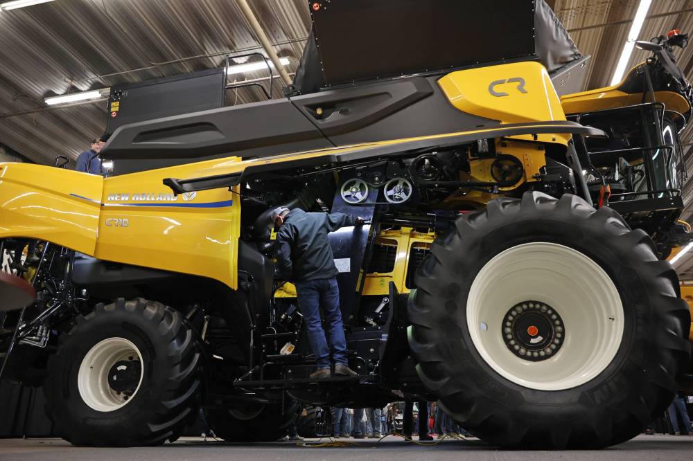 A visitor looks over a New Holland combine on the final day of Manitoba Ag Days at the Keystone Centre on Thursday.
