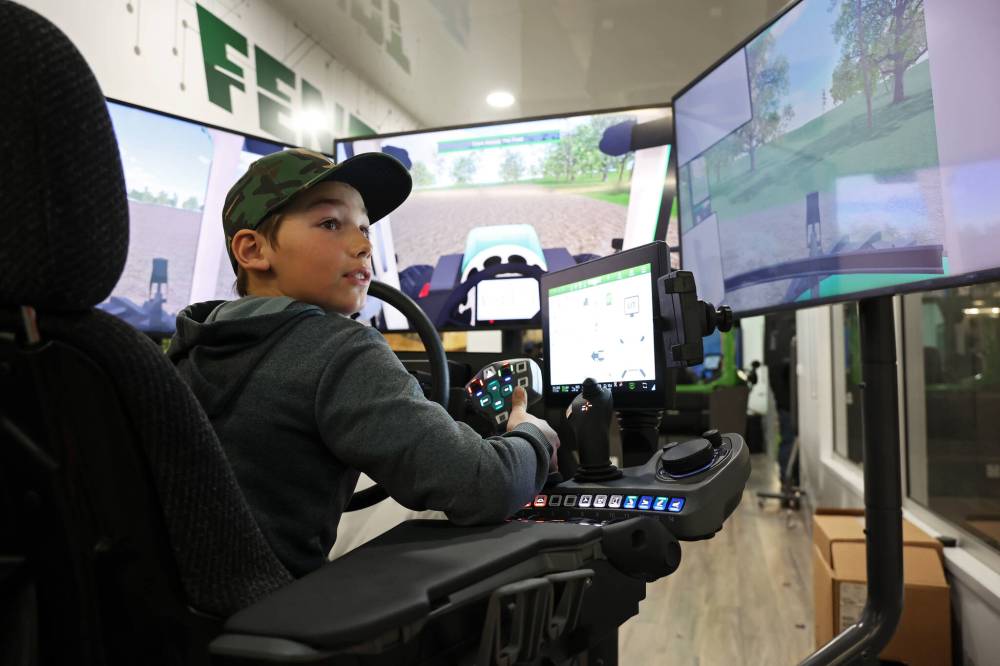 Nine-year-old Brody Higgott of Newdale looks at a screen behind him while trying out an AGCO Fendt simulator set up for tractor and planting simulation during the final day of Manitoba Ag Days at the Keystone Centre on Thursday.