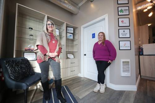 Lora Hay, the Prairie Mountain regional outreach manager for the Mood Disorders Association of Manitoba (left) stands with Alycia Canada, administrative assistant for MDAM’s Prairie Mountain region, in the entrance of their new location at Unit B, 1003 13th St. in Brandon. (Matt Goerzen/The Brandon Sun)