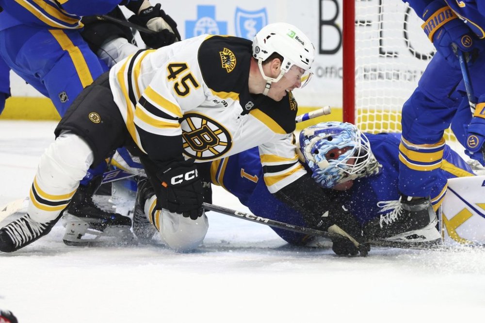 Boston Bruins left wing Cole Koepke (45) collides with Buffalo Sabres goaltender Ukko-Pekka Luukkonen in the crease during the second period of an NHL hockey game, Tuesday, Jan. 28, 2025, in Buffalo, N.Y. (AP Photo/Jeffrey T. Barnes)
