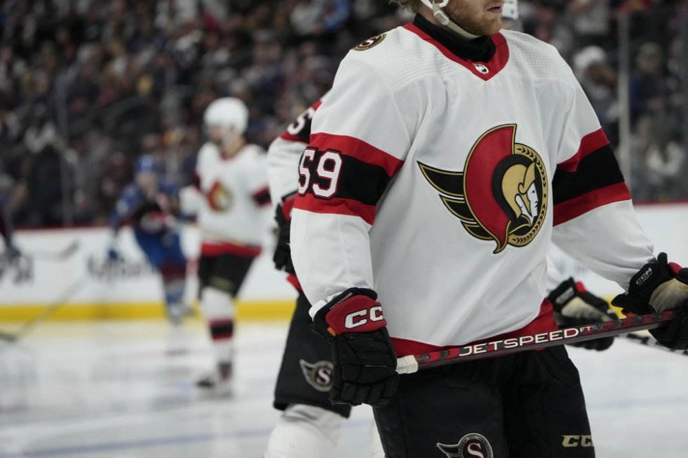 Ottawa Senators left wing Angus Crookshank (59) has the team logo displayed on the front of his sweater during third period NHL hockey in Denver, Thursday, Dec. 21, 2023. THE CANADIAN PRESS/AP-David Zalubowski