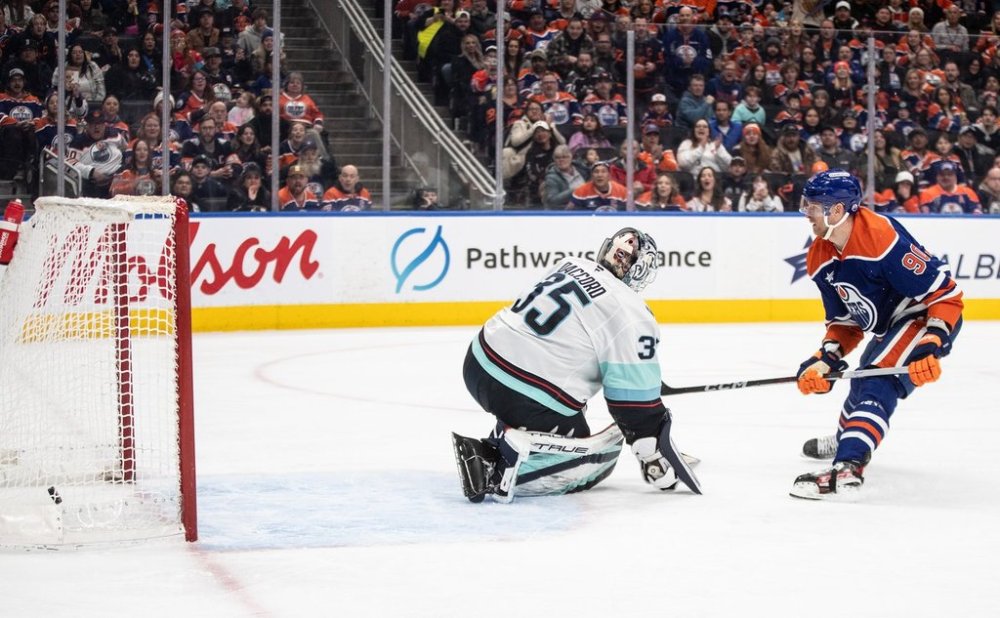Seattle Kraken goalie Joey Daccord (35) is scored on by Edmonton Oilers' Corey Perry (90) during second period NHL action in Edmonton on Monday, Jan. 27, 2025. THE CANADIAN PRESS/Jason Franson