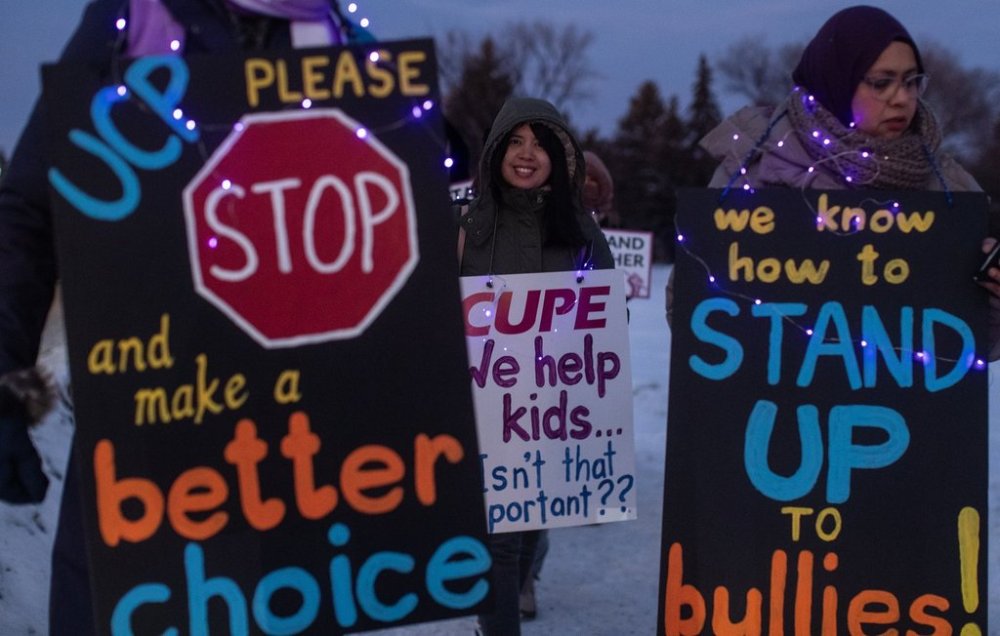 Union members and supporters picket for better education funding, and more classroom support in Edmonton, on Monday, Jan. 13, 2025. A strike by thousands of school support workers in Alberta is poised to get bigger as unions for two more divisions reach an impasse. THE CANADIAN PRESS/Jason Franson