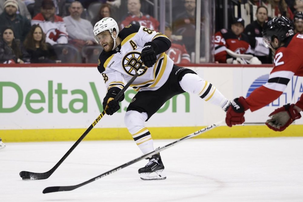 Boston Bruins right wing David Pastrnak (88) shoots the puck during the first period of an NHL hockey game against the New Jersey Devils Wednesday, Jan. 22, 2025, in Newark, N.J. Pastrnak, Anaheim Ducks centre Mason McTavish and Utah Hockey Club centre Barrett Hayton are the NHL's three stars of the week. THE CANADIAN PRESS/AP/Adam Hunger
