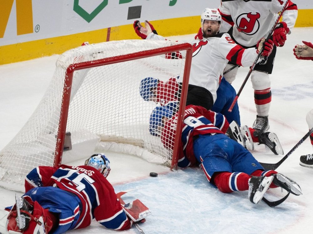 New Jersey Devils' Tomas Tatar (90) celebrates his goal on Montreal Canadiens goaltender Jakub Dobes (75) during second period NHL hockey action in Montreal on Saturday, Jan. 25, 2025. THE CANADIAN PRESS/Christinne Muschi