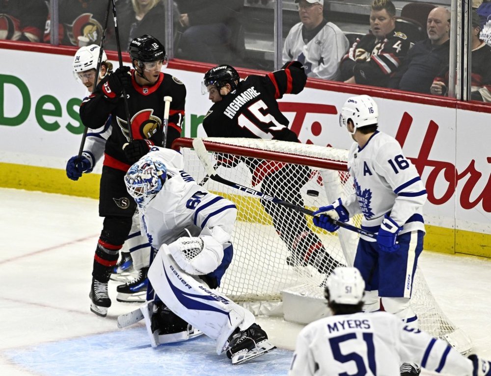 Ottawa Senators' Shane Pinto (12) scores on Toronto Maple Leafs goaltender Joseph Woll (60) during third period NHL hockey action in Ottawa, on Saturday, Jan. 25, 2025. THE CANADIAN PRESS/Justin Tang