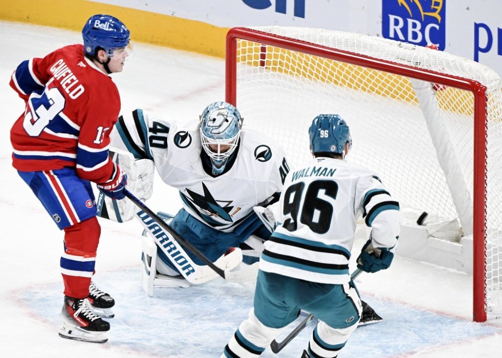 Montreal Canadiens' Cole Caufield (13) scores against San Jose Sharks goaltender Alexandar Georgiev as Sharks' Jake Walman (96) defends during overtime NHL hockey action in Montreal, Thursday, February 27, 2025. THE CANADIAN PRESS/Graham Hughes