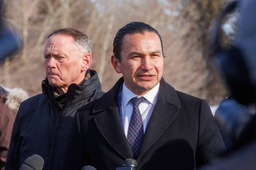 Premier Wab Kinew speaks to the media in Emerson on Tuesday while federal Public Safety Minister David McGuinty listens. McGuinty, Kinew, federal Sport Minister Terry Duguid, minister responsible for Prairies Economic Development Canada and Winnipeg South Centre Liberal MP Ben Carr met with law enforcement officers from the Canadian Border Services Agency, RCMP, Manitoba Conservation and Manitoba First Nations Police Service to talk about border security measures. (Mike Deal/Winnipeg Free Press)