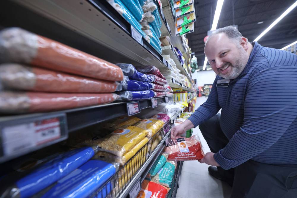 In this recent photo, Richmond Avenue Heritage Co-op food store manager Dan Lange displays a bag of lentils that were produced in Western Canada as customers have asked for Canadian-made products due to U.S. tariff threats that have since become reality. It's an example of how Canadians can adjust their buying habits to take a stand.