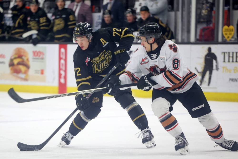 Marcus Nguyen plays the puck as Kalem Parker tries to get his stick in the way in Friday’s game. (Tim Smith/The Brandon Sun)