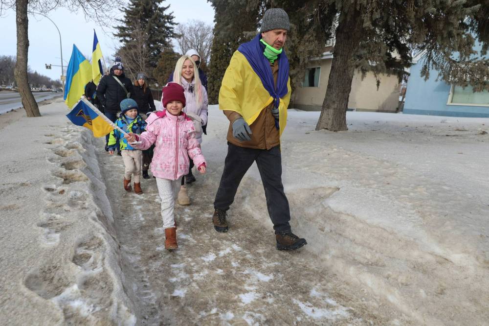Children smile as they join the solidarity march.
