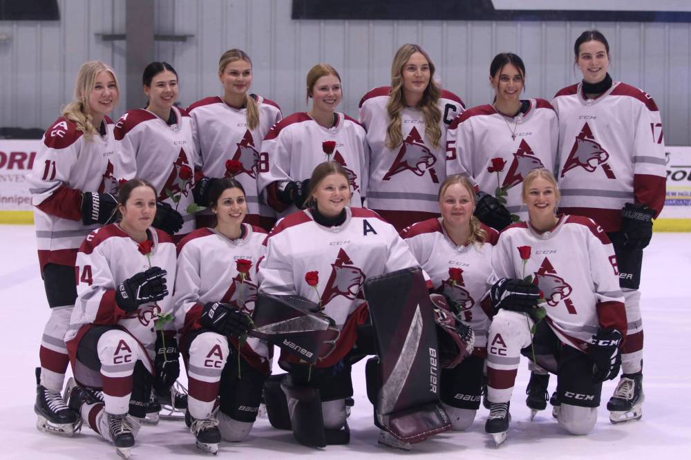 The graduating Assiniboine College Cougars women's hockey team members pose for a photo prior to last Saturday's game against North Dakota State University. (Matt Packwood/The Brandon Sun)