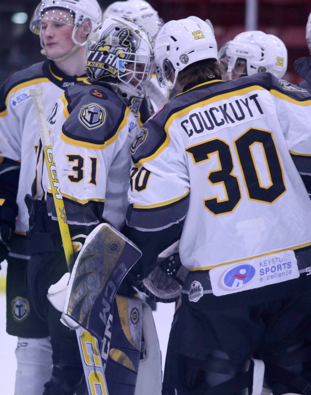 Mason Lobreau (31) and KC Couckuyt (30) bump helmets following a Neepawa Titans win. (Matt Packwood/The Brandon Sun)
