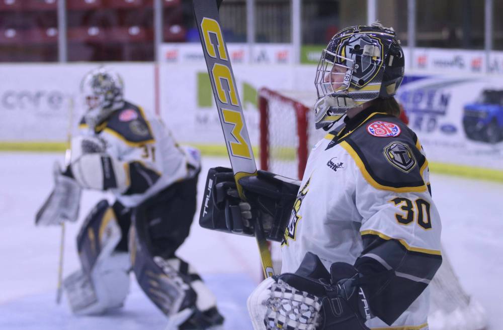 Neepawa Titans goaltender KC Couckuyt (30) looks on while Mason Lobreau warms up ahead of last Thursday's game against the Virden Oil Capitals. (Matt Packwood/The Brandon Sun)