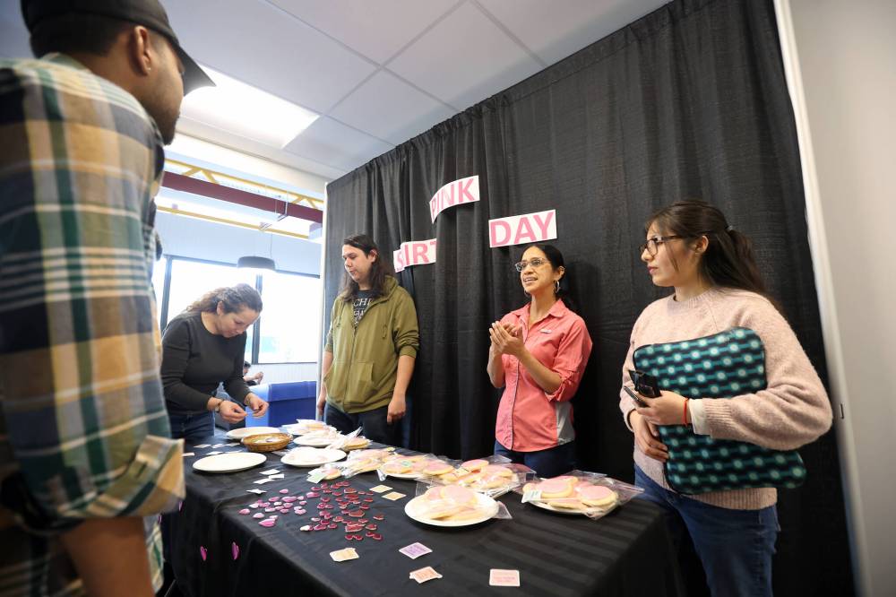 Jimmy Teichroeb, president of the Assiniboine College Students’ Association, Natalia Daqui, the Students’ Association representative for the school of agriculture and environment, and Monica Chira, vice-president of diversity and inclusion for the Students’ Association, offer free pink cookies from Chez Angela to fellow students at the college on Wednesday in honour of Pink Shirt Day, which is an annual event against bullying. The Assiniboine students’ association held the event at both Brandon campuses to promote kindness.