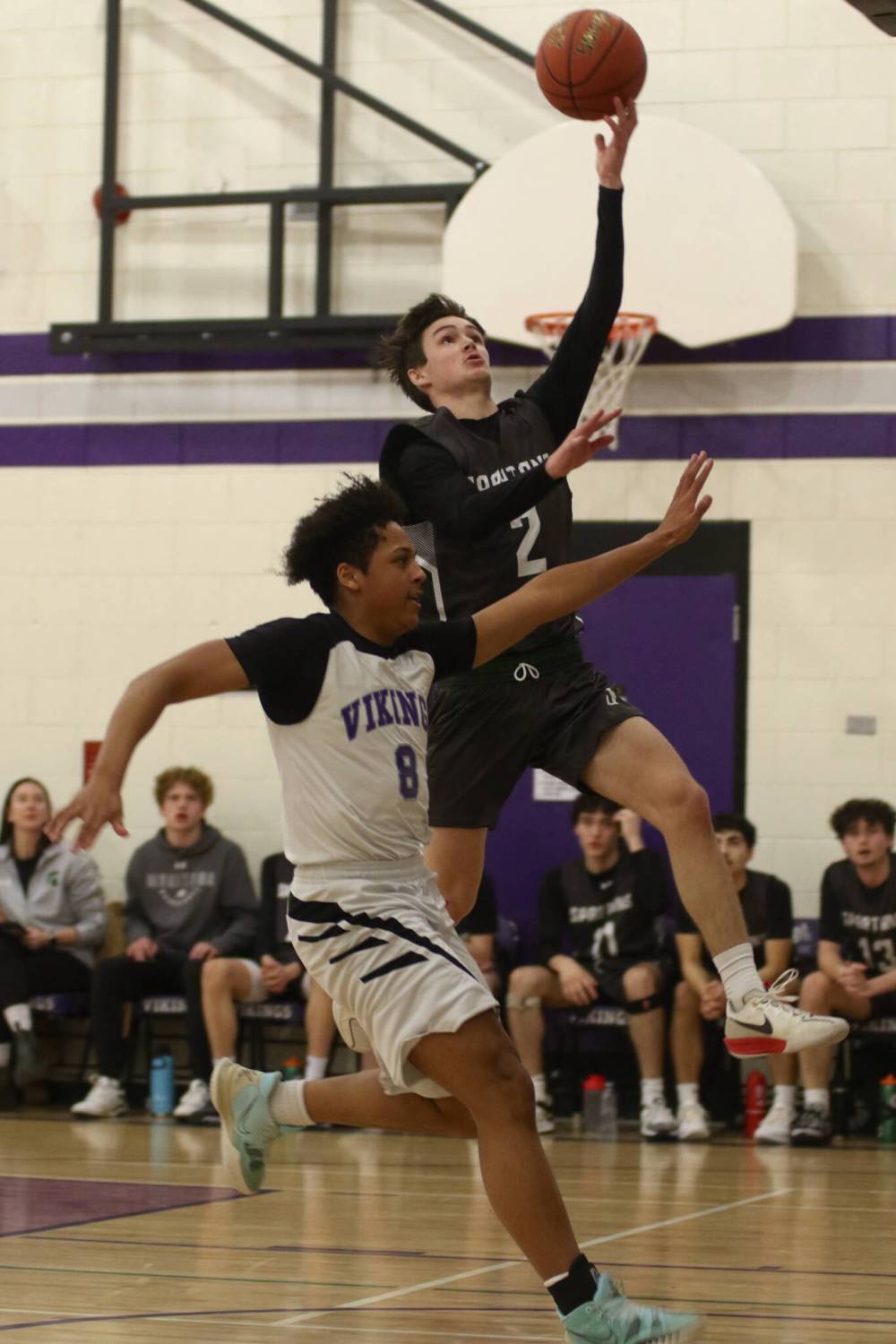 Neelin Spartans Junior Martine goes for a layup while Vincent Massey Vikings Knox Smith defends during Game 2 of the Brandon High School Basketball League varsity boys' final at Massey on Wednesday. The Vikings won 73-52 to sweep the series. (Thomas Friesen/The Brandon Sun)