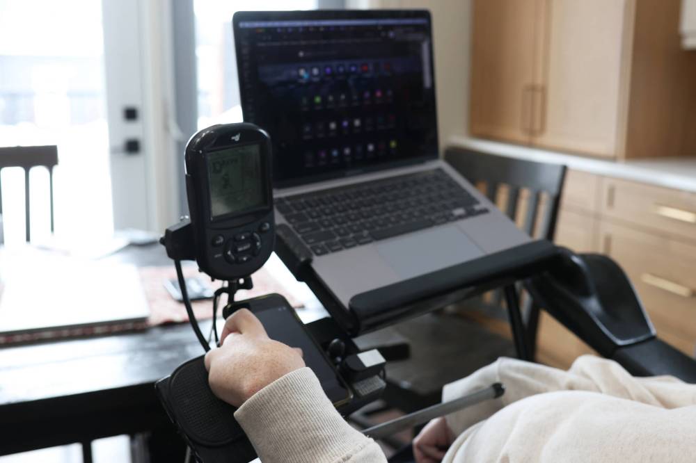 Bray uses an iPhone and adaptive technology to work in IT from Rivers. “I only have the use of my left thumb and my face and voice, so really, once I lose my thumb, which will happen at some point, I’ll lose the ability to work, to drive my wheelchair, to do a lot of what gives my life meaning,” he says.