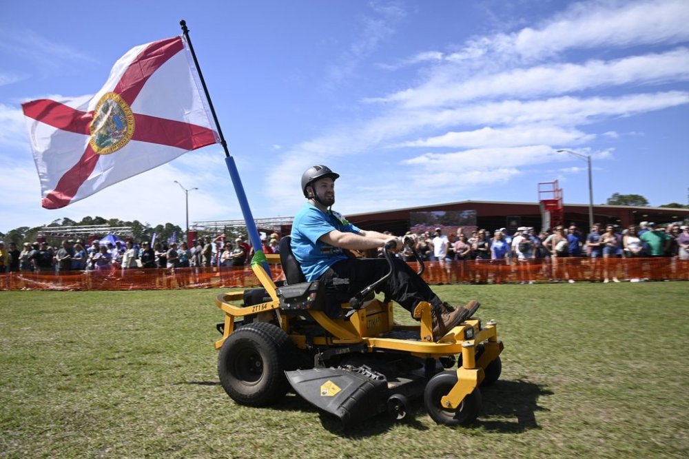 Blake Setser, of Jacksonville, Fla., competes in the lawnmower racing event during the Florida Man Games, Saturday, March 1, 2025, in Elkton, Fla. (AP Photo/Phelan M. Ebenhack)
