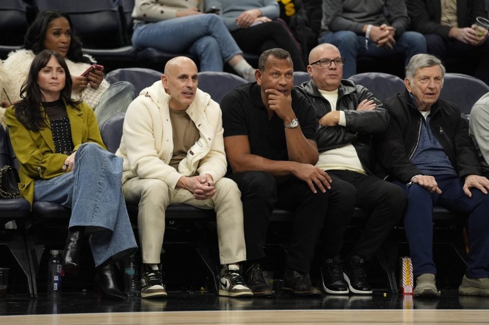 FILE - Minnesota Timberwolves minority owners Marc Lore, middle left, and Alex Rodriguez, middle right, watch during the second half of an NBA basketball game against the New York Knicks Dec. 19, 2024, in Minneapolis. (AP Photo/Abbie Parr, File)