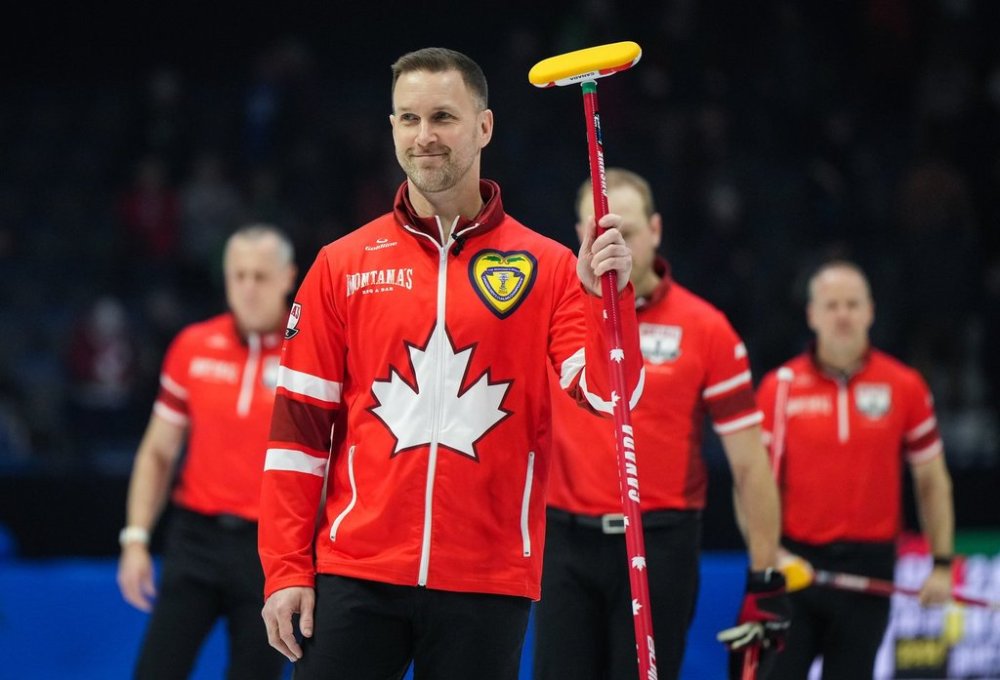 Team Canada skip Brad Gushue raises his broom to the crowd after defeating Team Alberta-Bottcher 7-3 during the playoffs at the Brier, in Regina, on Saturday, March 9, 2024. THE CANADIAN PRESS/Darryl Dyck