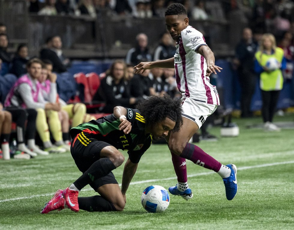 Vancouver Whitecaps' Jayden Nelson (left) and Deportivo Saprissa's Ryan Bolanos (19) vie for the ball during the second half of a CONCACAF Champions Cup soccer match in Vancouver, on Thursday, February 27, 2025. Jayden Nelson wanted to make a big impression in his return to Major League Soccer. With four assists and a goal in his first two games for the Vancouver Whitecaps, he's done just that. THE CANADIAN PRESS/Ethan Cairns
