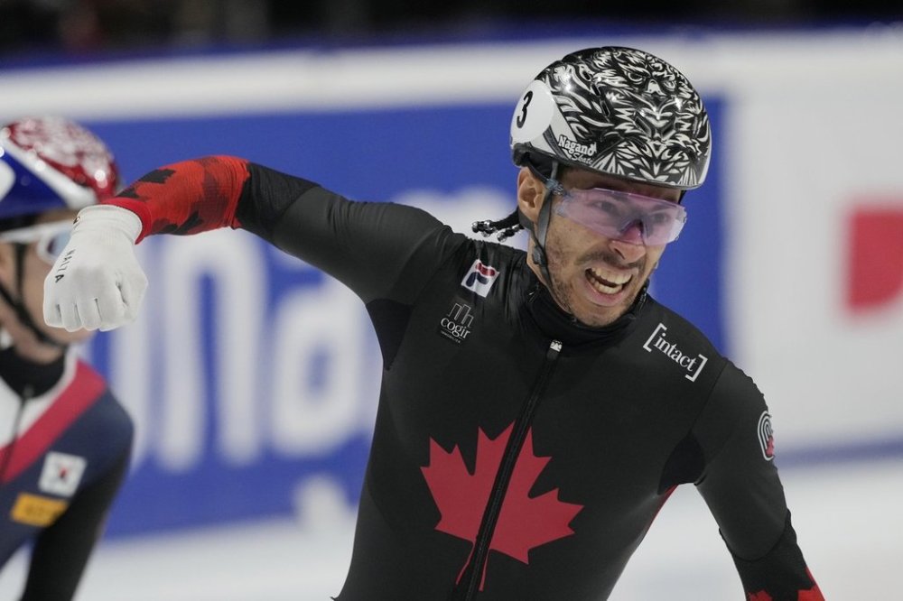 Canada's William Dandjinou celebrates after winning the gold medal in the men's 1000 meters final of the ISU Short Track World Tour and Olympics Milano-Cortina 2026 test event, in Milan, Italy, Sunday, Feb. 16, 2025. THE CANADIAN PRESS/AP-Luca Bruno
