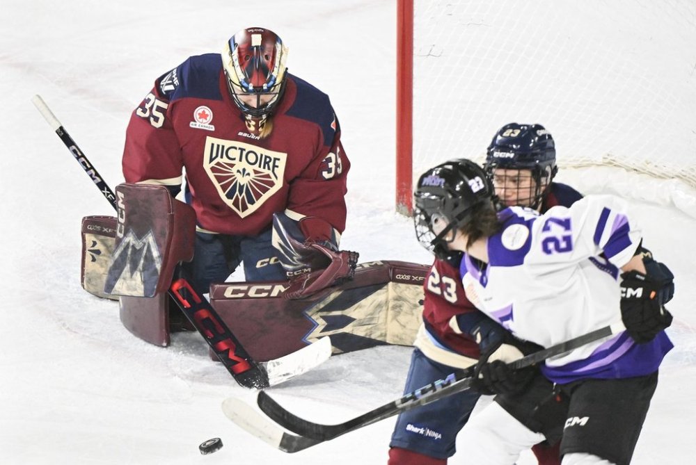 Minnesota Frost's Taylor Heise (27) moves in on Montreal Victoire goaltender Ann-Renee Desbiens (35) as Victoire's Erin Ambrose (23) defends during first period PWHL hockey action in Laval, Que. Tuesday, March 4, 2025. THE CANADIAN PRESS/Graham Hughes