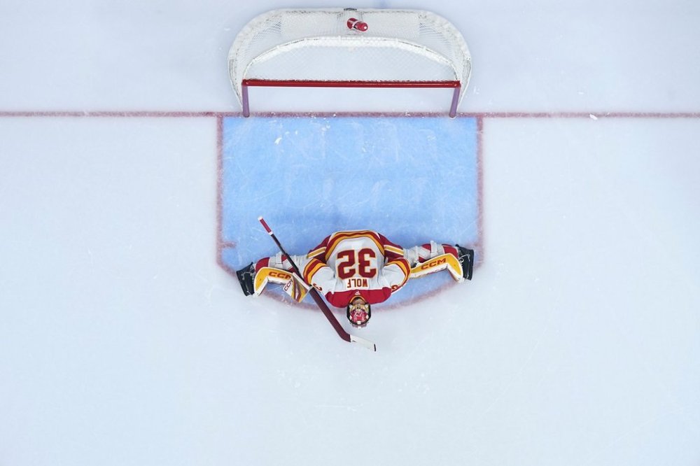 Calgary Flames' Dustin Wolf stretches before the second period of an NHL hockey game against the Philadelphia Flyers Tuesday, March 4, 2025, in Philadelphia. (AP Photo/Matt Slocum)