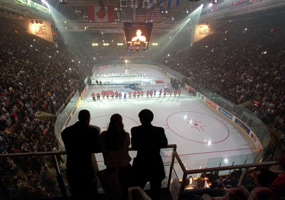 Three ushers watch as Chicago Blackhawks and Toronto Maple Leafs players line up for the playing of the national anthems before the start of the Leafs' final game at Maple Leaf Gardens, in Toronto, Saturday, Feb. 13, 1999. THE CANADIAN PRESS/Frank Gunn