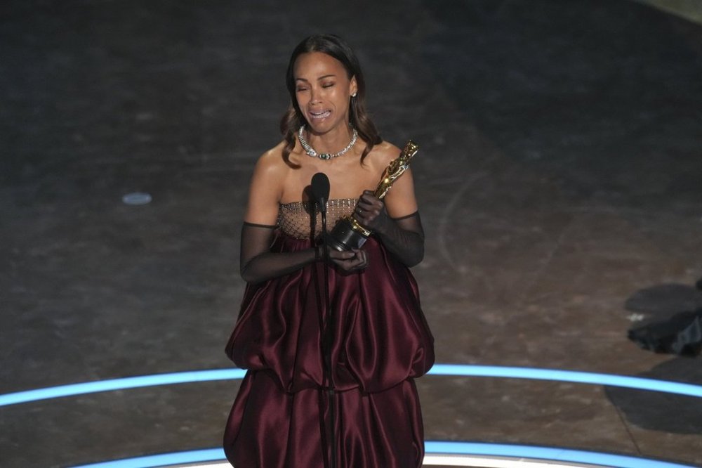 Zoe Saldana accepts the award for best performance by an actress in a supporting role for
