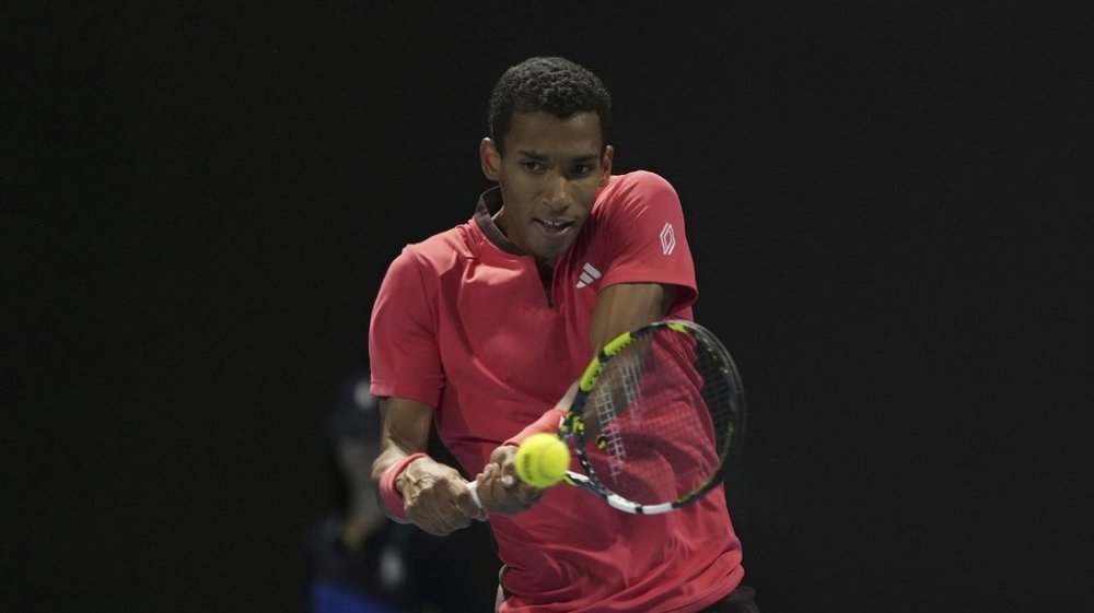 Felix Auger-Aliassime of Canada plays a backhand return to Alejandro Davidovich Fokina of Spain during their second round match at the Australian Open tennis championship in Melbourne, Australia, on January 15, 2025. THE CANADIAN PRESS/AP, Asanka Brendon Ratnayake